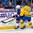BUFFALO, NEW YORK - JANUARY 4: Sweden's Glenn Gustafsson #12 pushes USA's Mikey Anderson #24 towards the boards during the semi-final round of the 2018 IIHF World Junior Championship. (Photo by Andrea Cardin/HHOF-IIHF Images)

